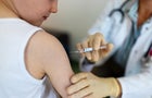 Boy getting a flu or coronavirus vaccine in the clinic 