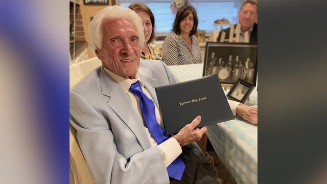 John Garofalo, a 95-year-old World War II veteran, holding his honorary diploma from Lyndhurst High School. 