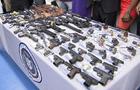 A table full of guns at a buyback event in Harlem 
