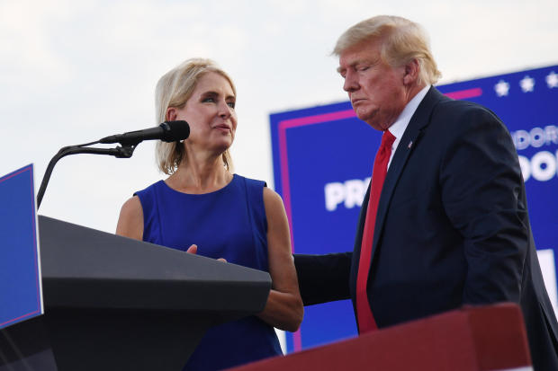 U.S. Rep. Mary Miller, a Republican from Illinois, is welcomed to the stage by former President Trump during a rally at the Adams County Fairgrounds on June 25, 2022, in Mendon, Illinois. 