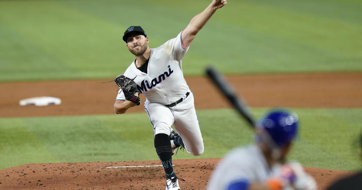 Miami Marlins first baseman Garrett Cooper (26) throws from the