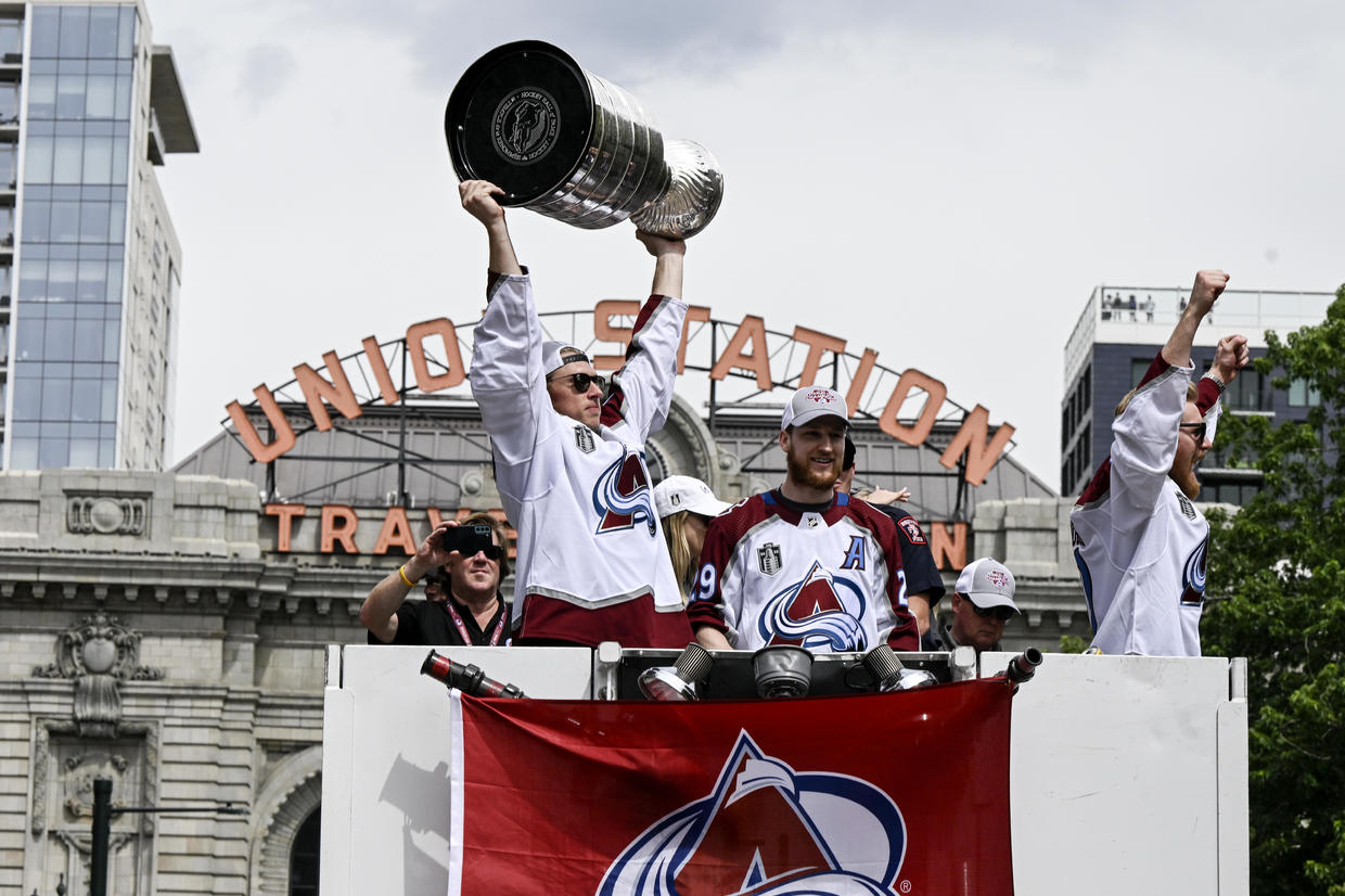 Avs players celebrate with fans during Stanley Cup Championship parade
