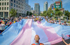 A giant Trans Flag seen at the march. Thousands of New 