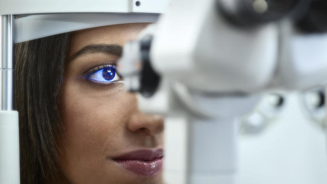 Optician, Young woman during eye test 