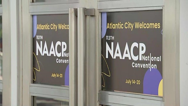 Signs on a convention center door read "Atlantic City welcomes 113th NAACP National Convention, July 14-20" 