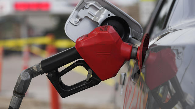 Close up senior man hands refueling his vehicle at gas station - Oil price increase concept 