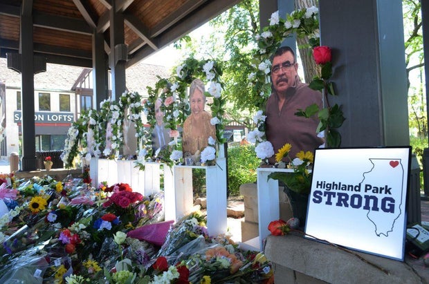 People lay flowers and cards near a spot where a mass shooting took place during the Fourth of July parade in Highland Park, Illinois, on July 10, 2022.