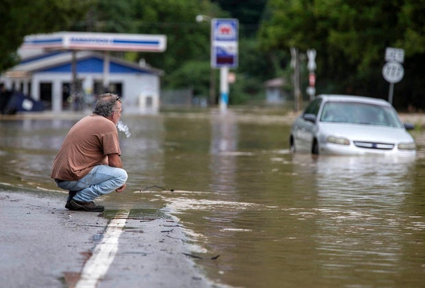 Van Jackson checks on his dog, Jack, who was stranded at a church by floodwaters following a day of heavy rain in Garrett, Kentucky, July 28, 2022. 