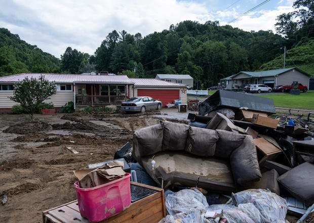Water-damaged items sit outside a house in Squabble Creek, Kentucky, following historic flooding in eastern Kentucky, July 31, 2022. 
