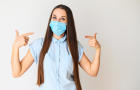 Positive young woman in medical mask 