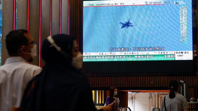 A TV screen shows that China's People's Liberation Army has begun military exercises including live firing on the waters and in the airspace surrounding the island of Taiwan, in Hong Kong 