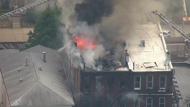 Fire and smoke could be seen shooting out of the roof of a residential building in Newark on Aug. 5, 2022. 