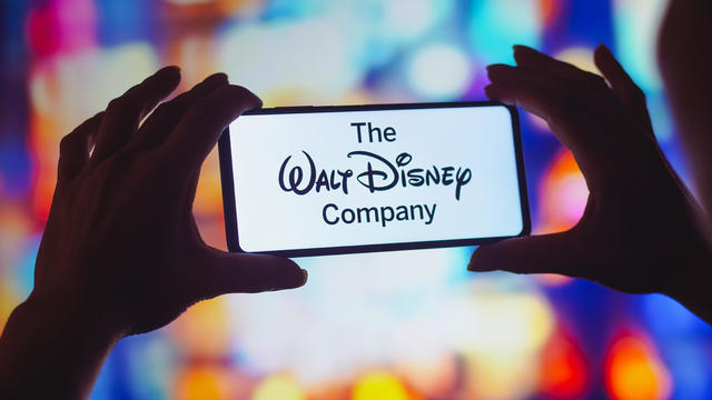 In this photo illustration, the Walt Disney Company logo is 
