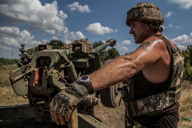 Ukrainian serviceman stand next to a D-30 howitzer near a frontline in Mykolaiv region 