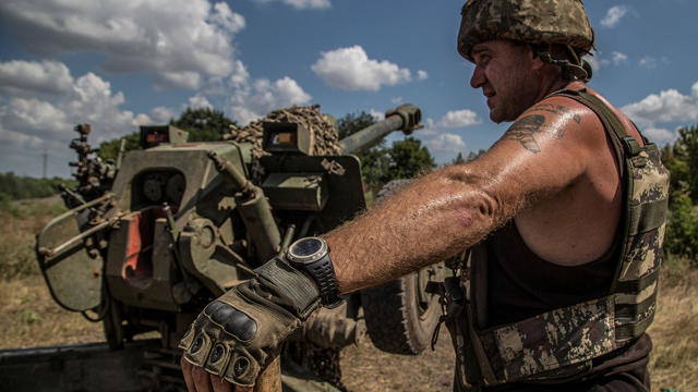 Ukrainian serviceman stand next to a D-30 howitzer near a frontline in Mykolaiv region 