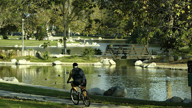 A bicyclist takes a scenic route Thursday, September 16, 2004 through Mile Square Regional Park in F 