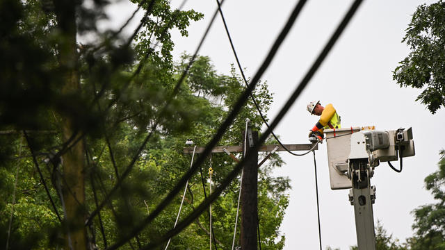 A Worker Fixes Downed Power Lines on Long Island Following Tropical Storm Isaias 