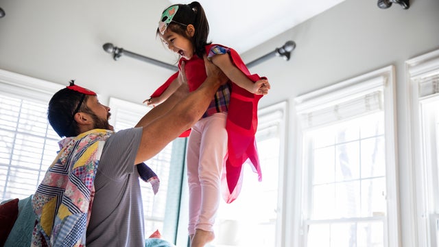 Father and daughter playing in homemade costumes 