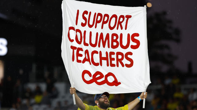 A Nordecke capo holds a sign in support of Columbus teachers in a match between the Columbus Crew and Atlanta United on August 21, 2022, at Lower.com Field in Columbus, Ohio. 