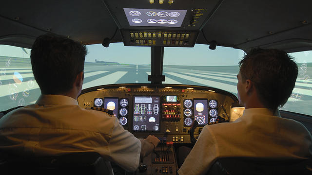 Pilots taxing on airport runway 