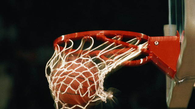 Basketball, ball going through hoop, close-up (blurred motion) 