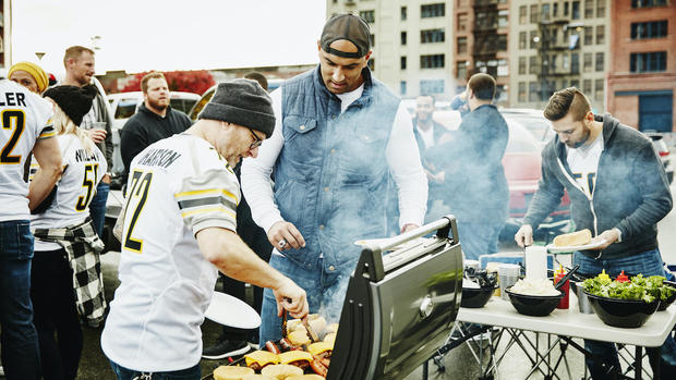 Men cooking at barbecue at tailgate 