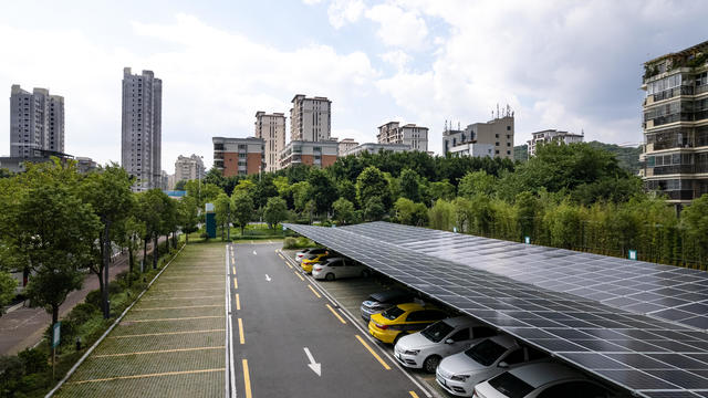 Urban parking lot with solar panels on the roof 