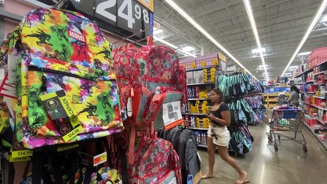 Backpacks and other school supplies are on display in a store. 