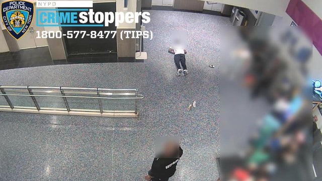 Surveillance photo shows a man laying on the floor inside the Kings Plaza Mall after being punched. 