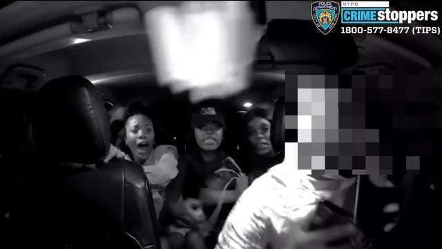 Footage from a dashboard camera shows three women in the back of a vehicle. 