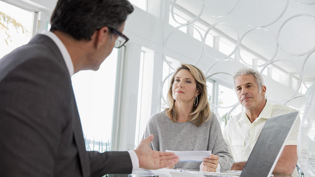 Couple talking to financial advisor 