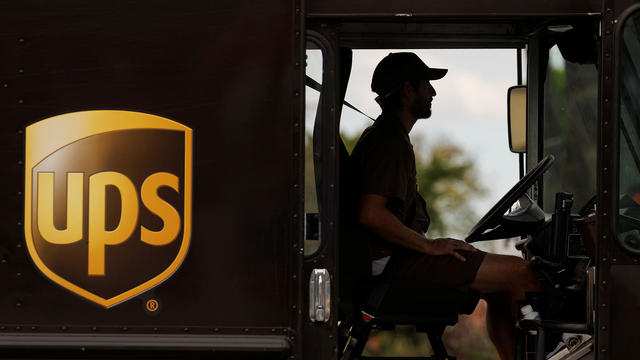 UPS delivery van is driven long a city street in Garden Grove, California 