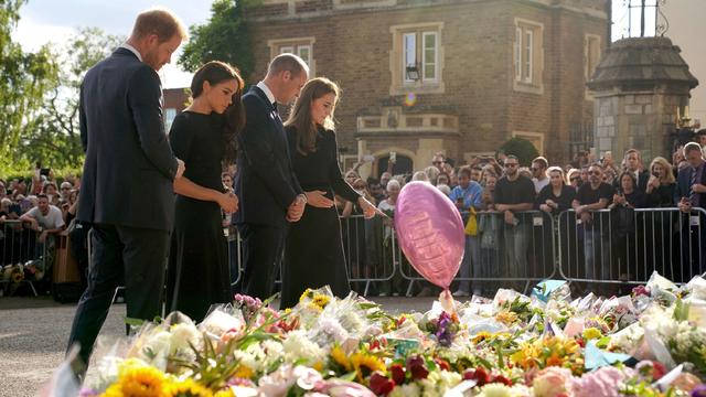 Britain's Prince Harry, Duke of Sussex, his wife Meghan, Duchess of Sussex, Britain's Prince William, Prince of Wales and his wife Britain's Catherine, Princess of Wales, look at floral tributes laid by members of the public on the Long walk at Windsor Ca 