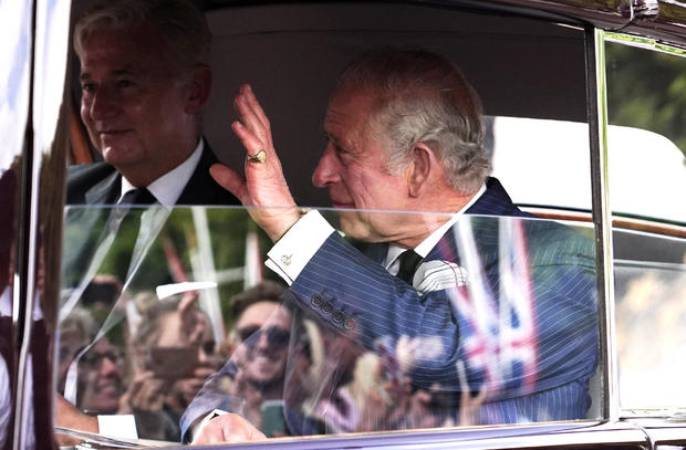 King Charles III waves to the crowd 