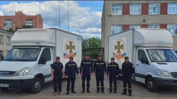 Ukrainian firefighters with rescue vans 