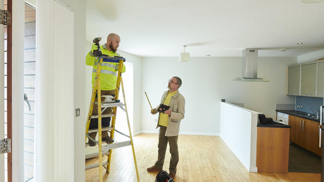 contractor and landlord making final repairs 