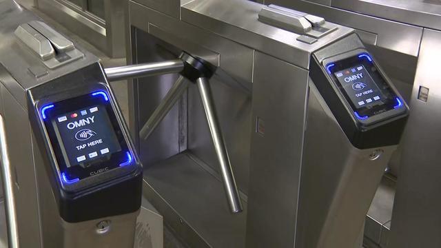 Tap-and-go OMNY scanners on turnstiles at the entrance to a New York City subway station. 
