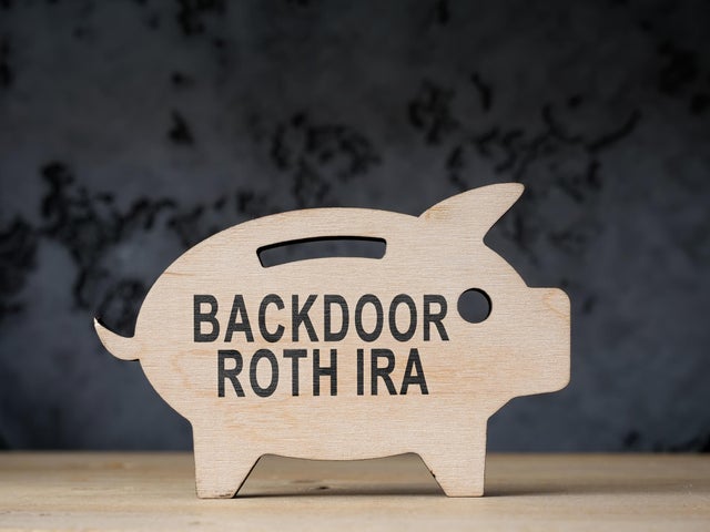 Wooden piggy bank with words backdoor Roth IRA. 