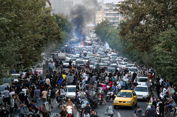 People stage a demonstration to protest the death of a 22-year-old woman under custody of the morality police, in Tehran, Iran, September 21, 2022. 