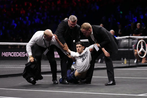 Protester lights arm and part of tennis court on fire during Laver Cup