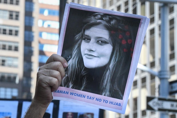 A protester holds up a photo of Mahsa Amini at a demonstration against visiting Iranian President Ebrahim Raisi, outside the United Nations, Sept. 21, 2022, in New York City