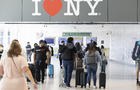 Travelers at John F. Kennedy International Airport (JFK) in the Queens borough of New York, US, on Friday, July 1, 2022. 