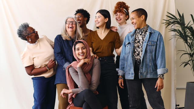 Portrait of cheerful mixed age range multi ethnic women celebrating International Women's Day 