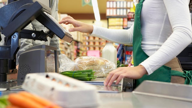 Cashier ringing up groceries 