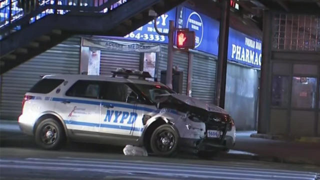 A parked NYPD vehicle with damage to its hood and front bumper. 