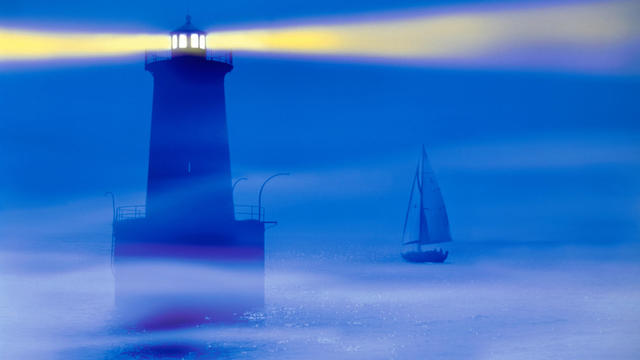 Lighthouse beacon slicing through fog (digital enhancement) 