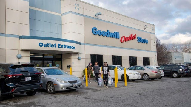 Women leaving the Goodwill outlet store in Kansas City, Missouri with bags of clothing. 