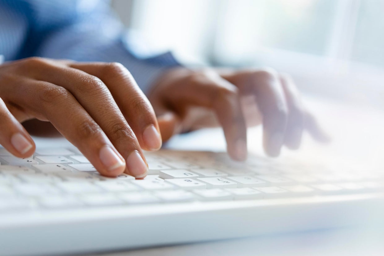 Hands of young woman typing on computer keyboard 