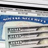 Social Security Card, benefits statement and 100 dollar bills. Social security funding, payment, retirement and federal government benefits concept 