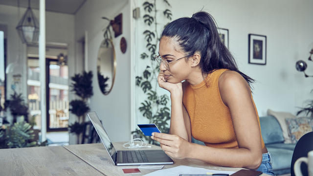 Beautiful woman doing finances at home 